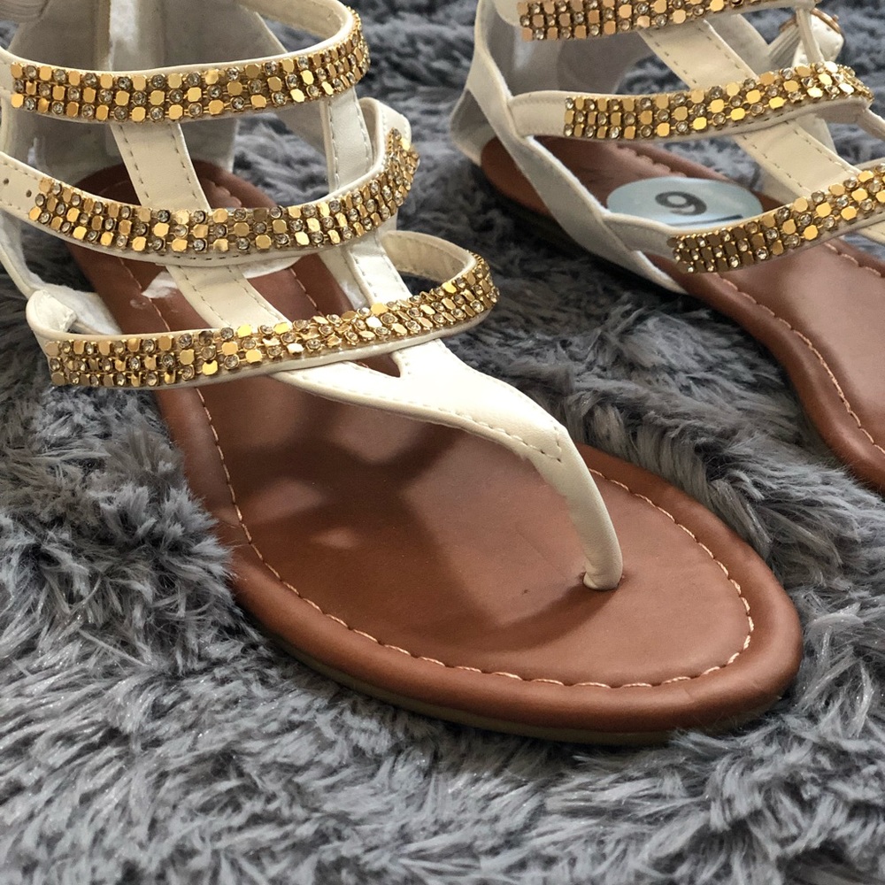 White sandals with gold accents